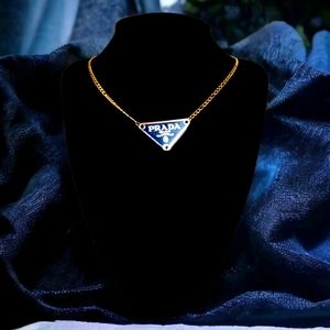 Triangle pendant on a stainless steel gold plated necklace